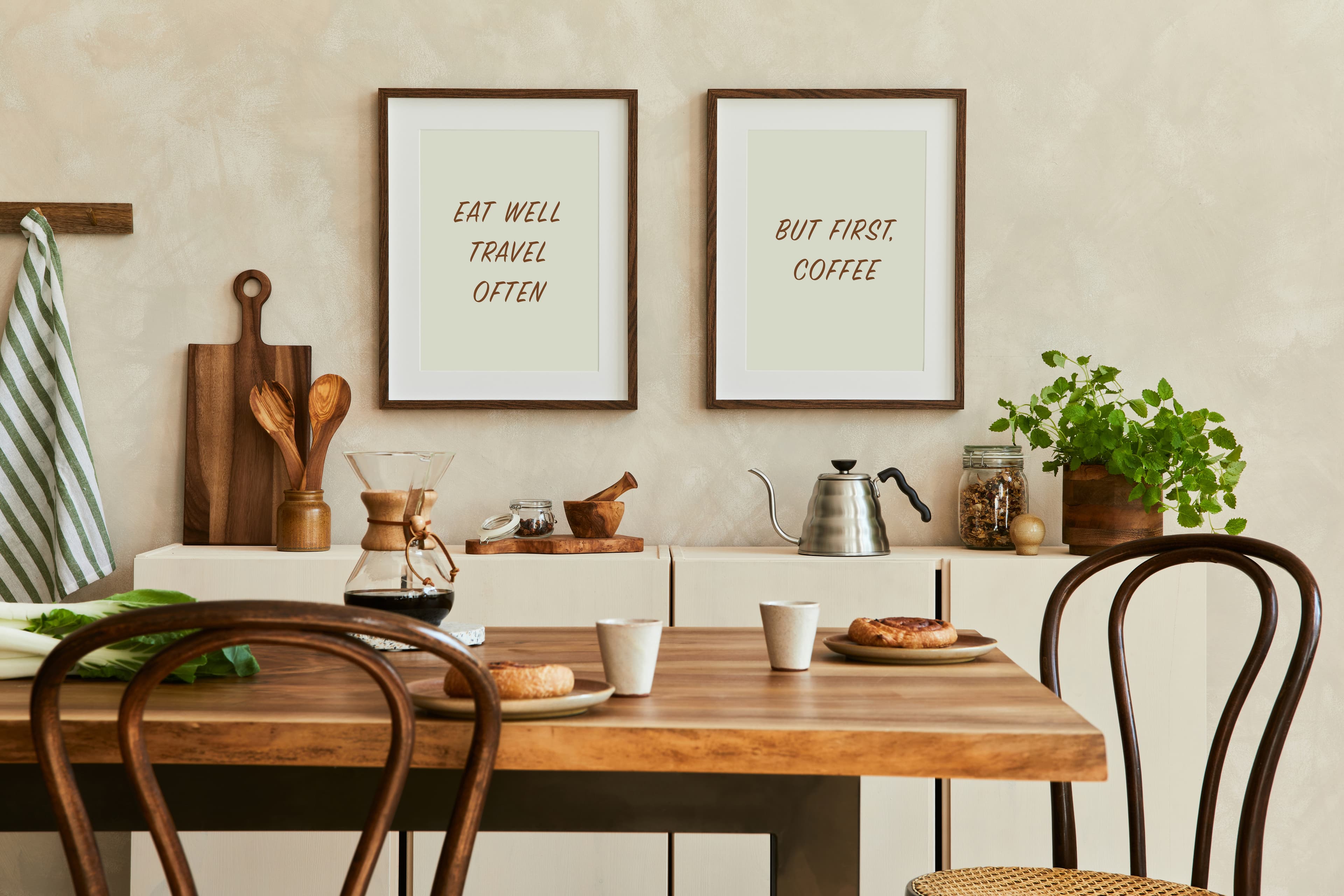 Two Brown Wood frames with coffee-themed prints displayed above kitchen table creating warm inviting breakfast nook atmosphere